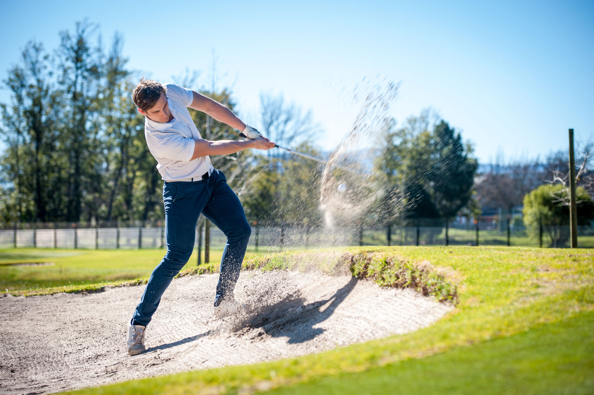 Golfer playing a chip shot onto the green
